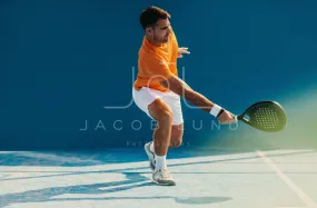 Athlete playing padel with impressive footwork on the court