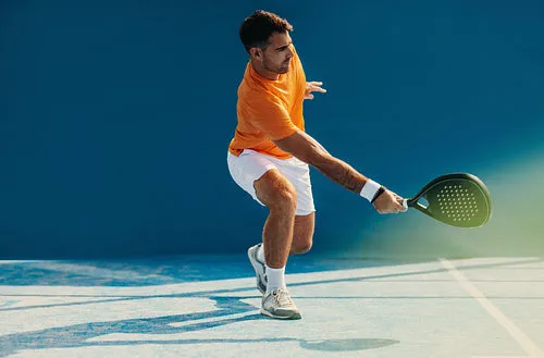 Athlete playing padel with impressive footwork on the court